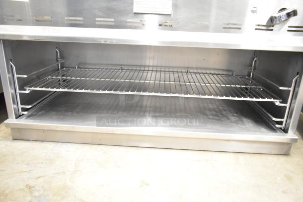 Cookline Commercial Gas Cheese Melter, stainless steel, open shelf, excellent condition, visible brand label.