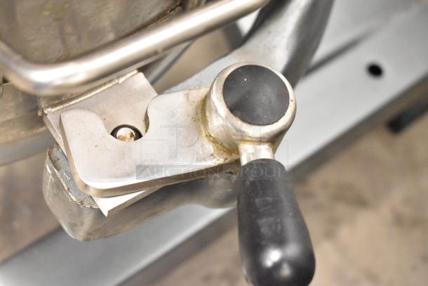 Close-up of Avantco MX40 dough mixer's handle and locking mechanism, showing metal finish and slight wear.