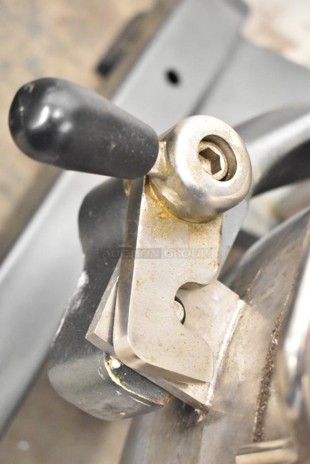 Close-up of lever on Avantco MX40 mixer, showing stainless steel finish and black handle. Used, with visible wear.