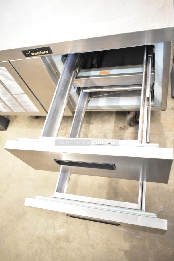 Delfield commercial 2-drawer chef base, stainless steel, on commercial casters. Visible logo, 115 volts, 1 phase.