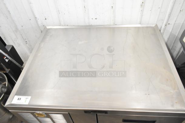 Delfield 2 Drawer Chef Base with stainless steel top, visible wear. Features commercial casters, 115 volts, 1 phase.