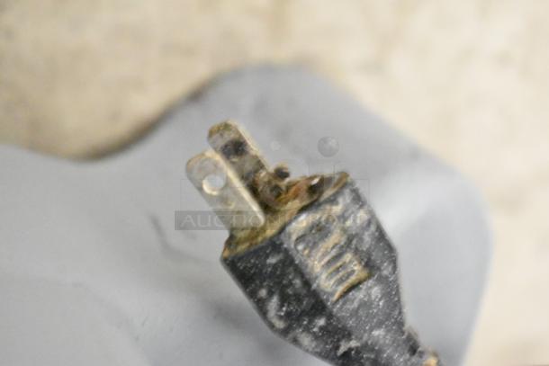 Close-up of the power plug for a Hobart Commercial Countertop Planetary Dough Mixer, showing signs of wear. 115 Volts, 1 Phase.