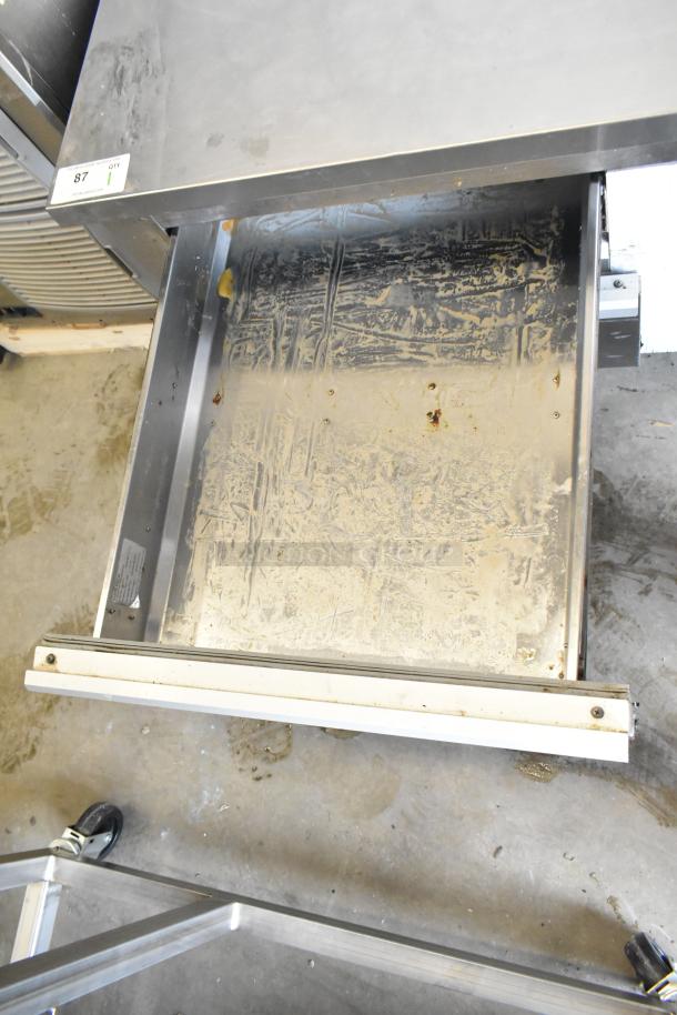 Cooltech CRI-52CF commercial chef base with two drawers on casters. Visible wear on interior. Runs on 115 volts, 1 phase.