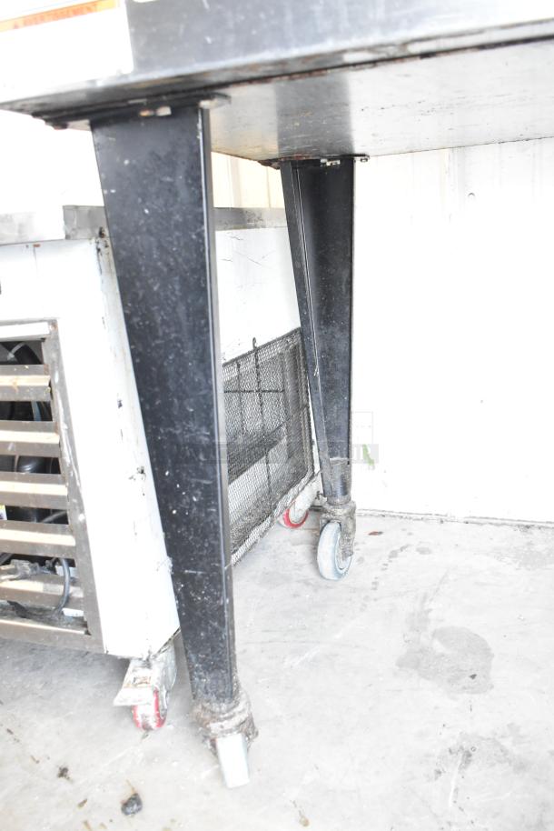 Vulcan commercial convection oven base with metal legs on casters. Features thermostatic controls and view-through door.