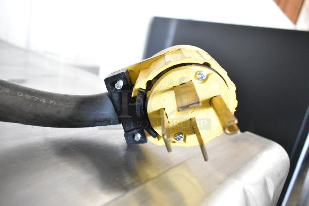 Turbochef HhC2020 commercial oven plug, yellow with three prongs, shown close-up, for 208/240 volts, 3 phase power.