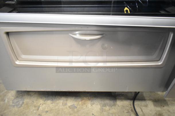 Crane 187D Commercial Floor Vending Machine, 115V, 1 Phase, silver finish, visible wear, suitable for snack or drink dispensing.