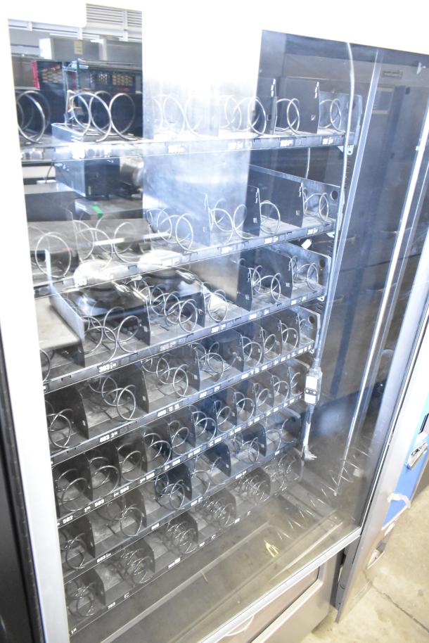 Crane 187D Commercial Floor Vending Machine, 115V, 1 Phase, multiple shelves, spiral dispensing, glass front.