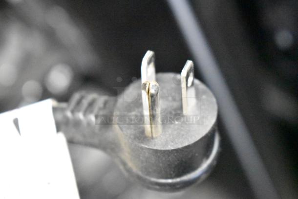 Close-up of a power plug for a Crane 187D vending machine, 115V, 1 phase, in good condition.
