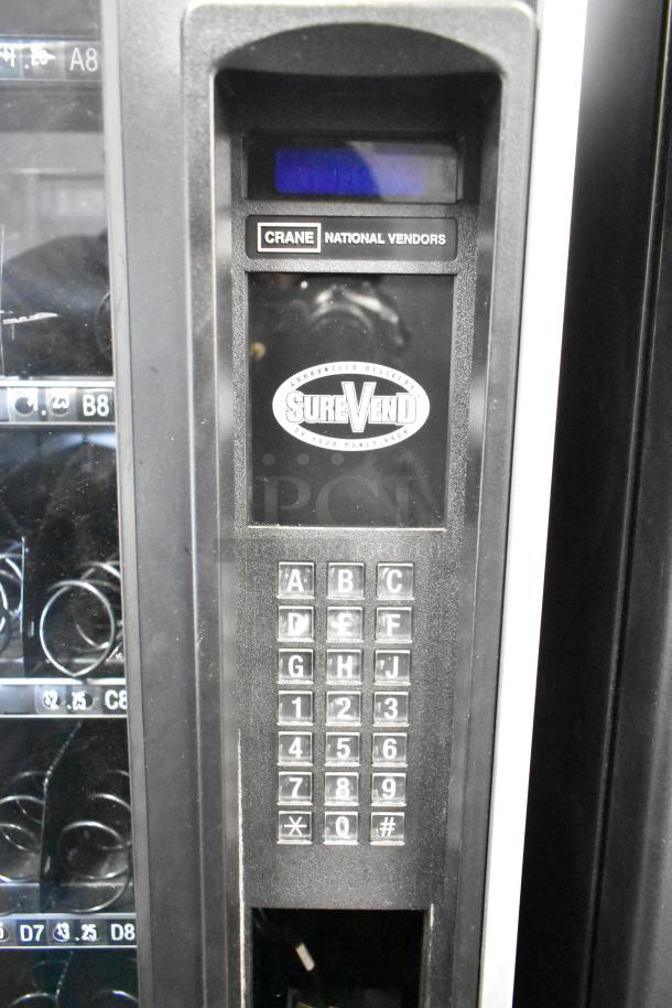 Crane 167 commercial floor vending machine, keypad visible, SureVend logo; 115 volts, 1 phase, excellent condition.