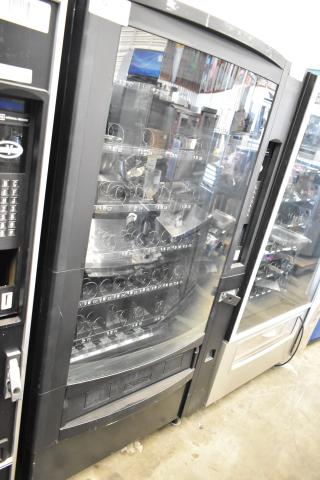 Crane 167 commercial vending machine in black, floor style, 115 volts, 1 phase, visible keypad and spiral racks.