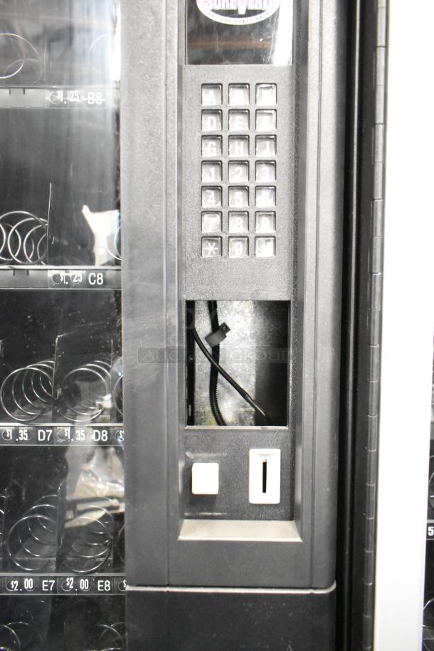 Crane 167 commercial floor vending machine, keypad present, coin slot visible, 115 volts, 1 phase, used condition.