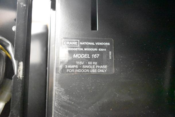 Crane 167 vending machine label, 115V, 60Hz, 3A, single phase, indoor use. Model details and branding visible.