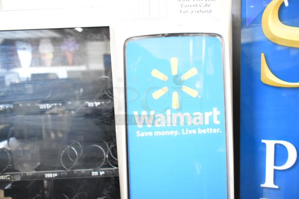 Crane 187D vending machine, commercial floor style, 115 volts, with visible product coils and Walmart branding.