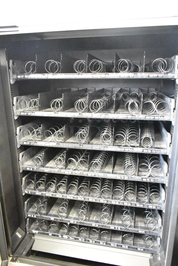 Crane 187D commercial floor vending machine, 115 volts, 1 phase, multiple trays with spiral coils, excellent condition.