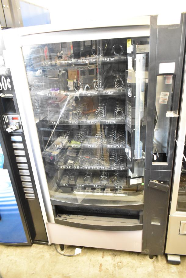 Crane 167 commercial floor vending machine, 115 volts, 1 phase, glass front, spiral dispensers, used condition.