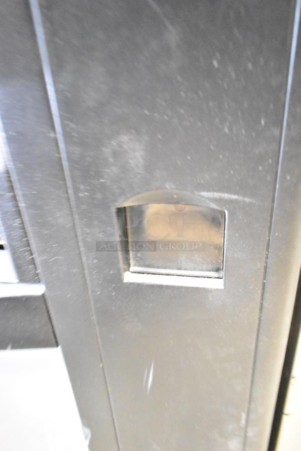 Crane 167 Commercial Floor Vending Machine, 115 volts, 1 phase, black finish, visible coin slot, used condition.