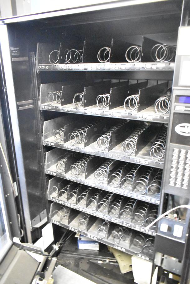 Crane 167 Vending Machine, commercial floor style, 115 volts, 1 phase. Multiple shelves shown empty, ready for use.