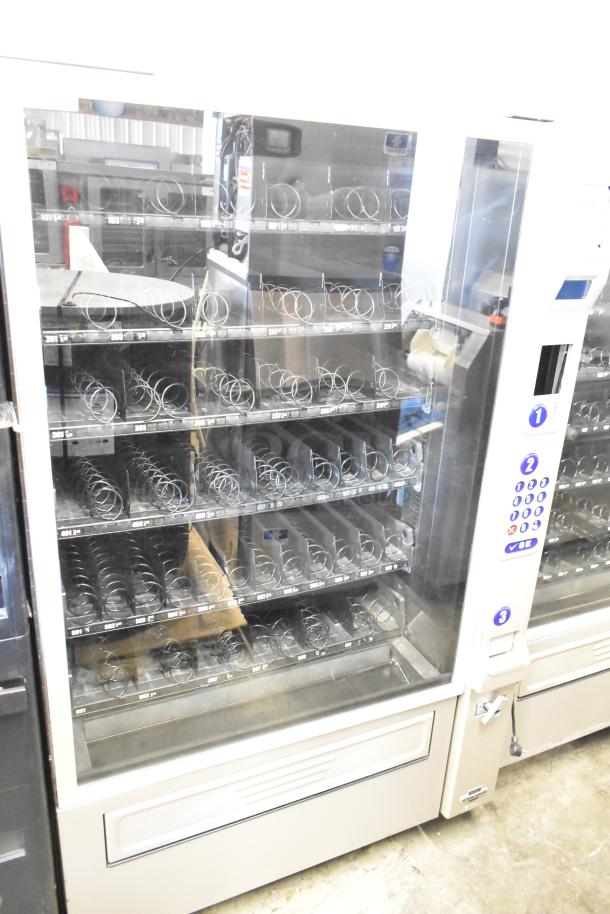 Crane 181 commercial vending machine, floor style, 115 volts, 1 phase, multiple shelves, keypad, glass front, used condition.