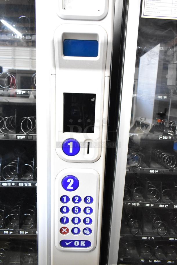 Crane 181 commercial vending machine, floor style, 115 volts, keypad controls, used condition, spiral dispensers visible.
