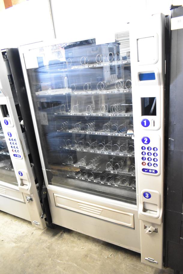 Crane 181 Commercial Floor Vending Machine, 115 Volts, 1 Phase, glass front, multiple shelves, keypad interface.