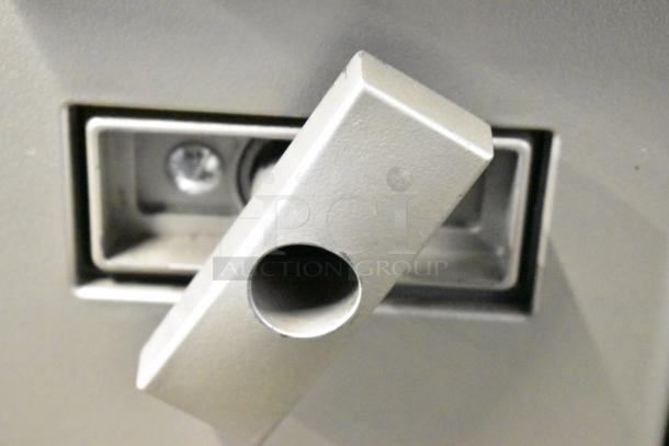 Close-up of Crane 181 vending machine handle, metallic finish, shows mechanism detail. In good condition, 115 volts, 1 phase.