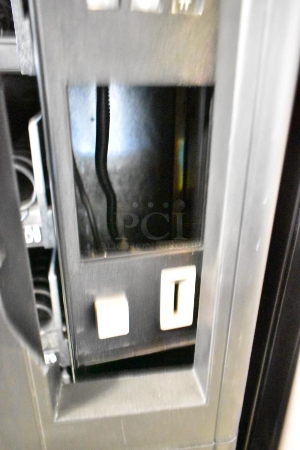 Crane 167 vending machine, commercial floor style, 115 volts, 1 phase. Features payment slot and controls, good condition.