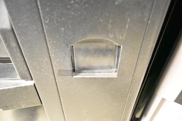 Crane 167 Commercial Floor Vending Machine, 115 Volts, 1 Phase. Black finish, showing front coin slot area, appears in used condition.