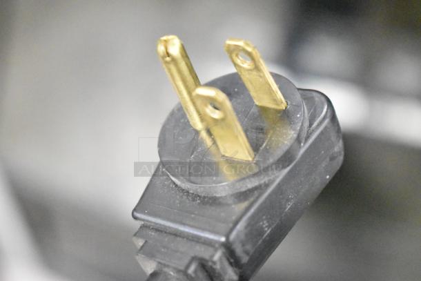 Close-up image of a power plug from a Crane 167 Commercial Floor Style Vending Machine, 115 volts, 1 phase.