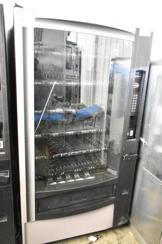 Crane 167 commercial vending machine; floor style, 115V, single phase, with multiple product slots and keypad.
