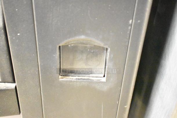 Crane 167 Commercial Floor Vending Machine, 115V, 1 Phase, showing close-up of coin slot. Used condition.