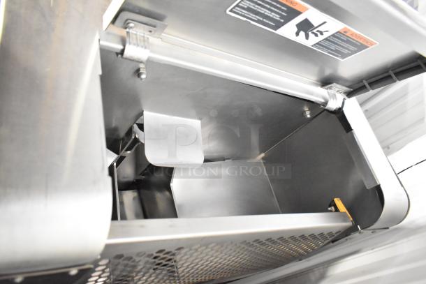 JBT Fresh N Squeeze Citrus Juicer; stainless steel interior, mounted on commercial casters. 115 Volts, 1 Phase.