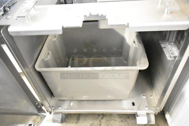 JBT Fresh N Squeeze Citrus Juicer, commercial floor style on casters, stainless steel, 115 volts, 1 phase, visible interior mechanism.