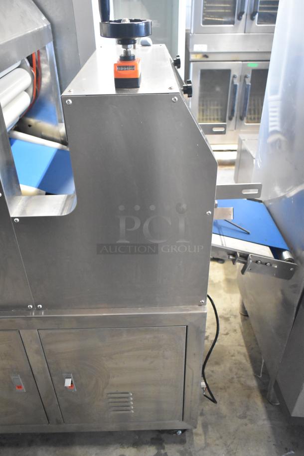 Commercial floor-style multi-roll dough sheeter on casters, 230 volts, stainless steel, visible control box, and conveyor.