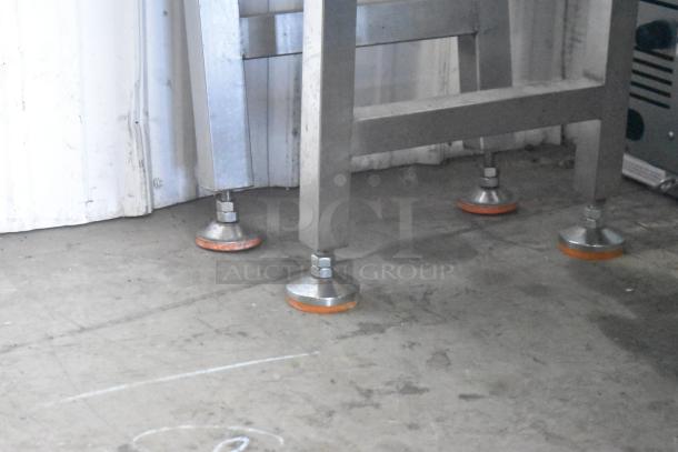 Commercial dough sheeter with multi-roll design on sturdy casters, 230 volts. Shown in good condition on solid flooring.