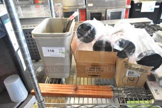 12 items including poly bins and cups on metal shelving. Box labeled "Cambro Round Food Storage Covers." Auction tag "110."