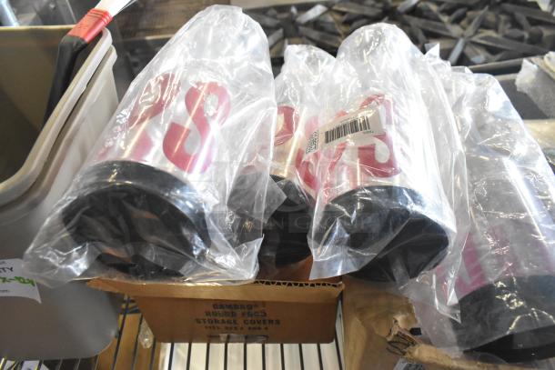 Clear poly cups in packaging, printed with 'S', on metal shelf. Included with other storage items and a Cambro box.