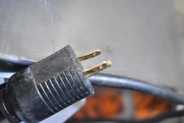 Close-up of a plug for the JBT 2ND-GEN-MFJ-HE Fresh N Squeeze Citrus Juicer, 115V, 1 Phase. Plug shows wear.