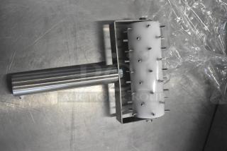 Stainless steel dough docker with plastic spiked roller, ideal for commercial baking. Good condition, enhances dough preparation.