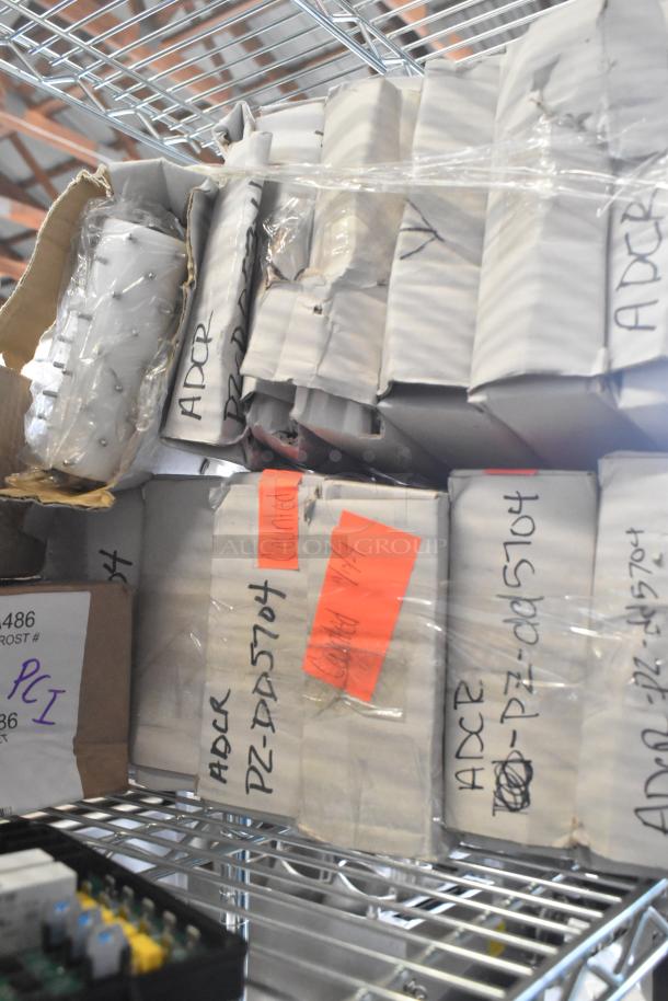 Boxes of various items, including dough dockers, labeled with "ADCR" and "PZ-DD5704" on metal shelving.