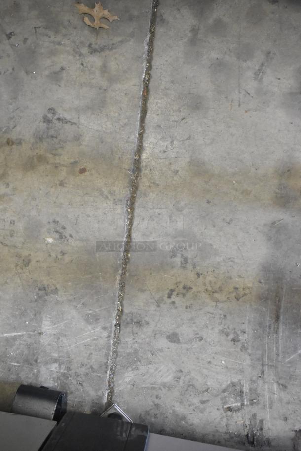 Floor with visible crack and oak leaf, part of an auction lot titled "15 Various Items Including Dough Dockers." Condition unclear.