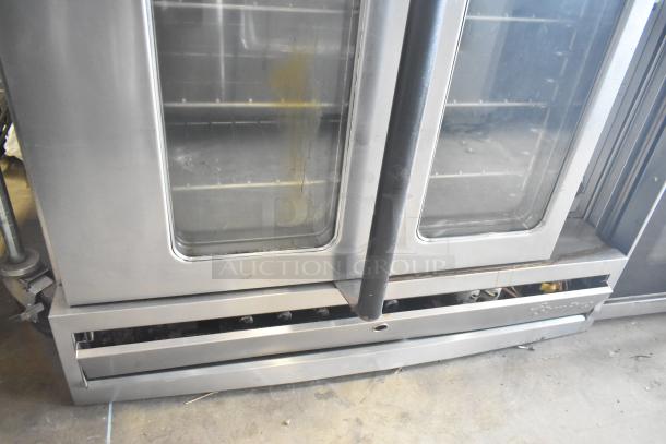 Garland SunFire gas convection oven with view-through doors, thermostatic controls, metal legs. Visible wear.