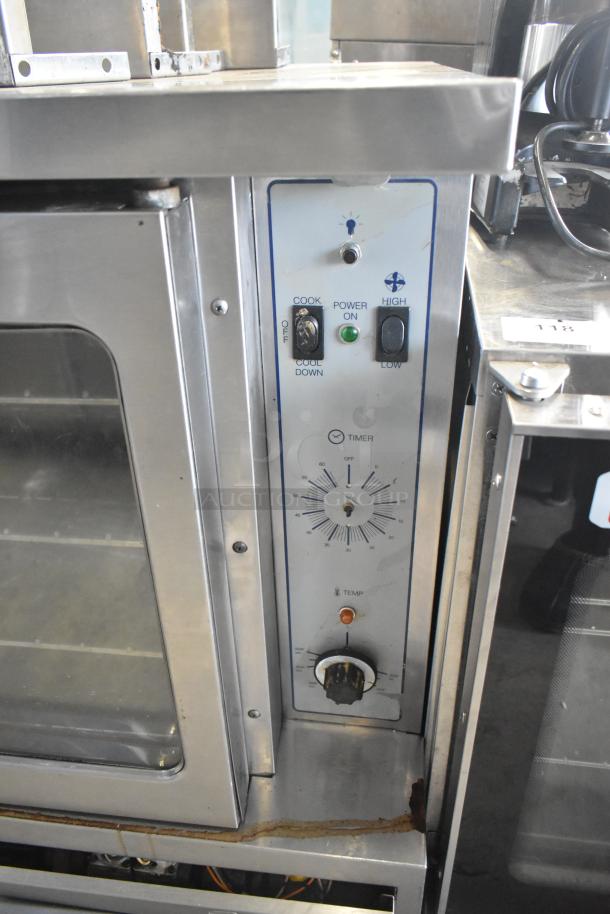 Garland SunFire gas convection oven with view-through doors, thermostatic controls, metal legs, and visible wear.