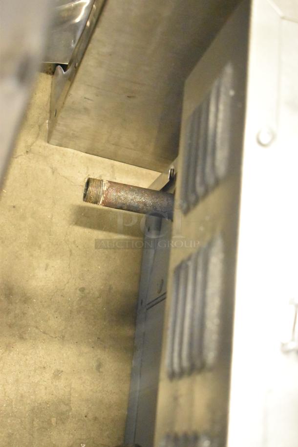 Garland SunFire convection oven side view showing a metal pipe and part of the structure; full size, gas powered, thermostatic controls.