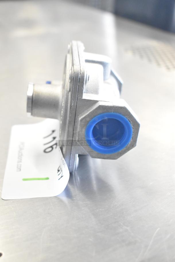 7015-4010 Gas Regulator in silver with blue fittings, new, on a metal surface. Auction tag partially visible.