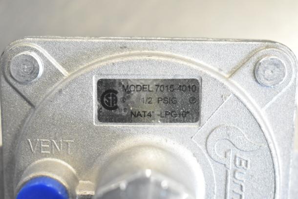 Silver gas regulator, model 7015-4010, labeled for 1/2 PSIG, NAT4-LPG10. Includes "VENT" marking. In good condition.