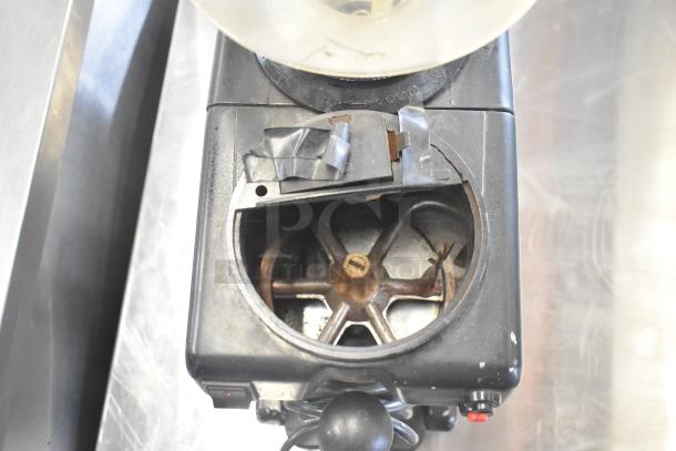Bregani countertop espresso bean grinder, no lid, 115 volts, 1 phase. Visible wear, tape seen on top, ideal for parts or repair.