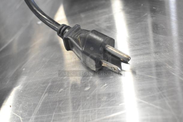 Bregani countertop espresso bean grinder plug on metallic surface, 115 volts, missing lid.