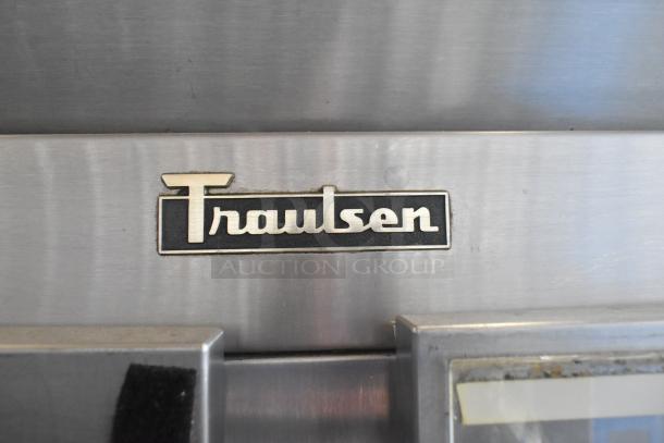 Traulsen RHT 2-32NUT cooler with four half-size doors, commercial casters, and Traulsen logo. 115 volts, 1 phase.