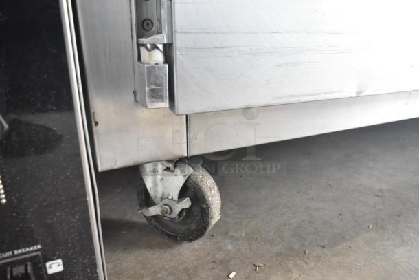 Traulsen RHT 2-32NUT cooler on commercial caster wheel. Stainless steel, visible wear. 115V, 1 phase.