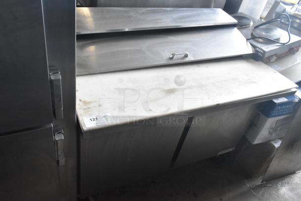 Beverage Air SPE48HC-12C prep table in stainless steel, with cutting board, commercial casters, slight surface wear.